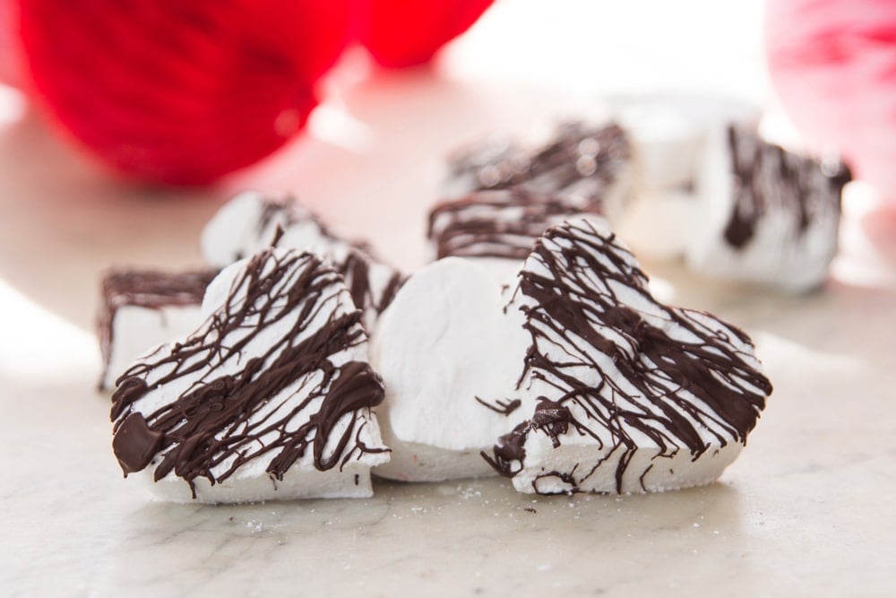 Two heart-shaped marshmallows on a table.