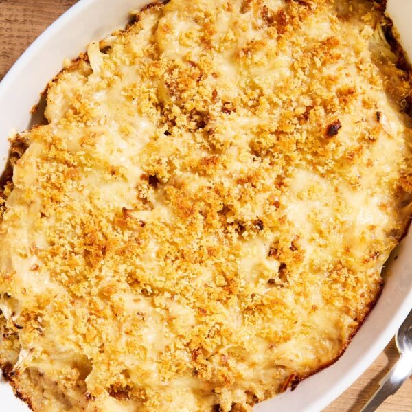 White baking dish filled with cauliflower au gratin after coming out of the oven with browned cheese-covered topping.
