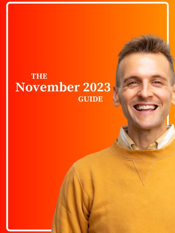 Kaleb Wyse standing in front of orange and yellow ombre background wearing yellow sweater with the words The November 2023 Guide.
