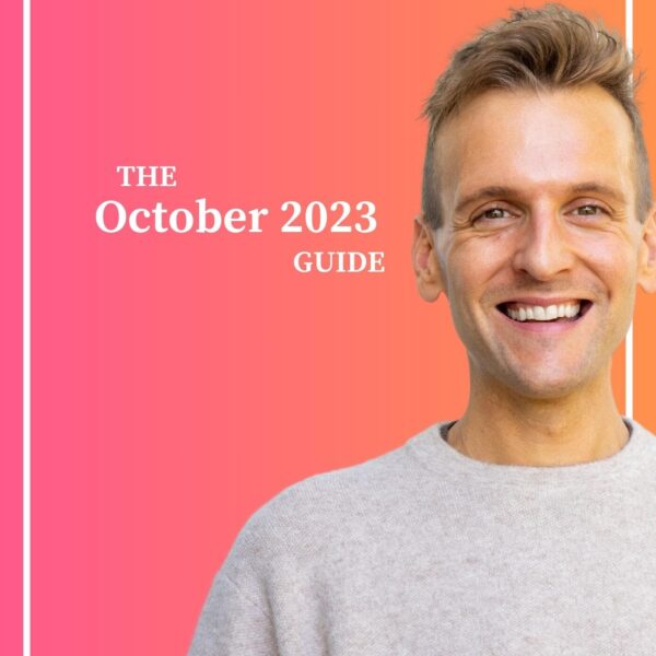 Kaleb Wyse wearing taupe sweater standing in front of ombre pink and orange background with the words The October 2023 Guide.