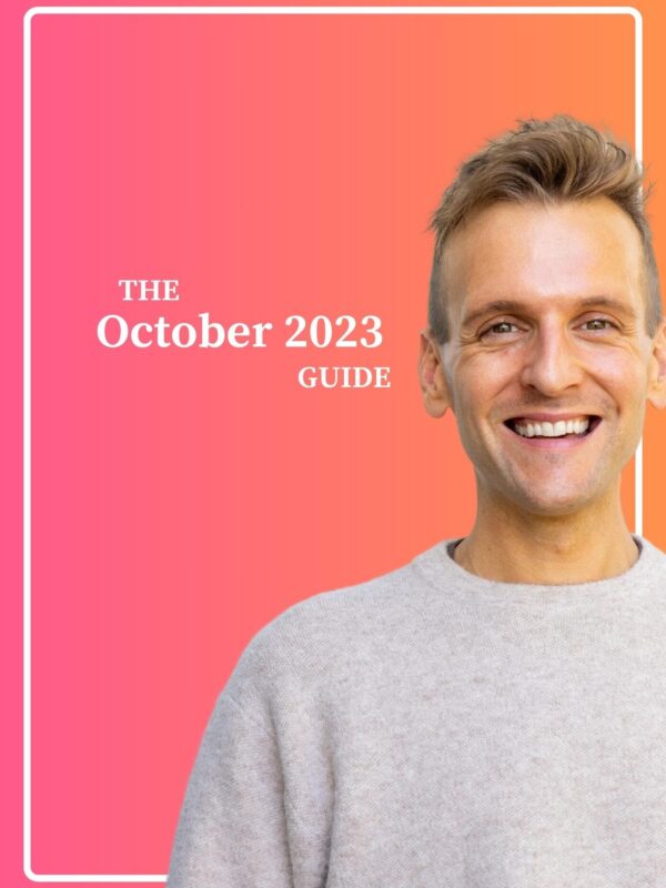 Kaleb Wyse wearing taupe sweater standing in front of ombre pink and orange background with the words The October 2023 Guide.