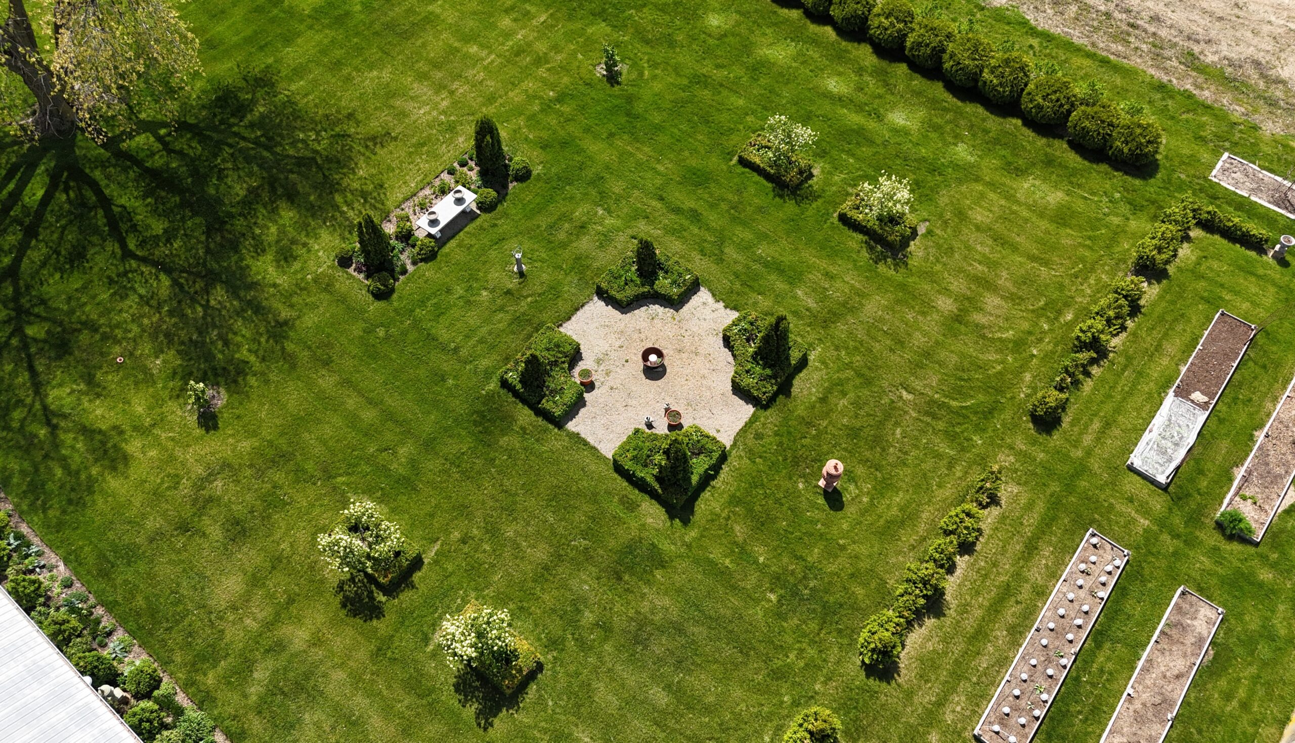Top down view of Kaleb Wyse's backyard with pea gravel path and lots of shrubs and trees.