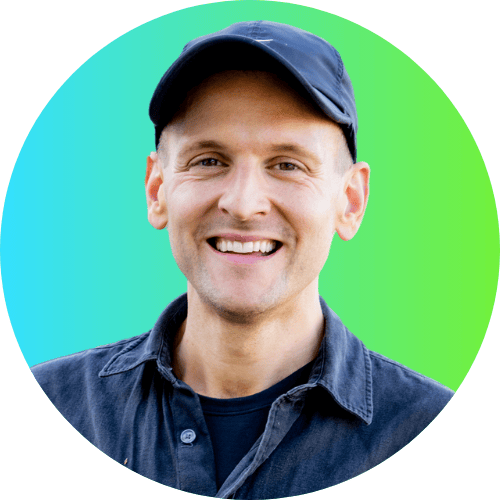 Kaleb Wyse wearing black shirt and black hat standing in front of blue to green ombre background.