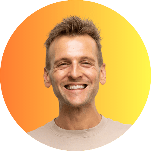 Kaleb Wyse wearing tan shirt standing in front of an orange and yellow ombre background.