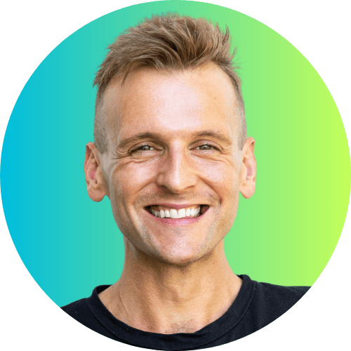 Kaleb Wyse wearing a black shirt standing in front of a blue to green ombre background.