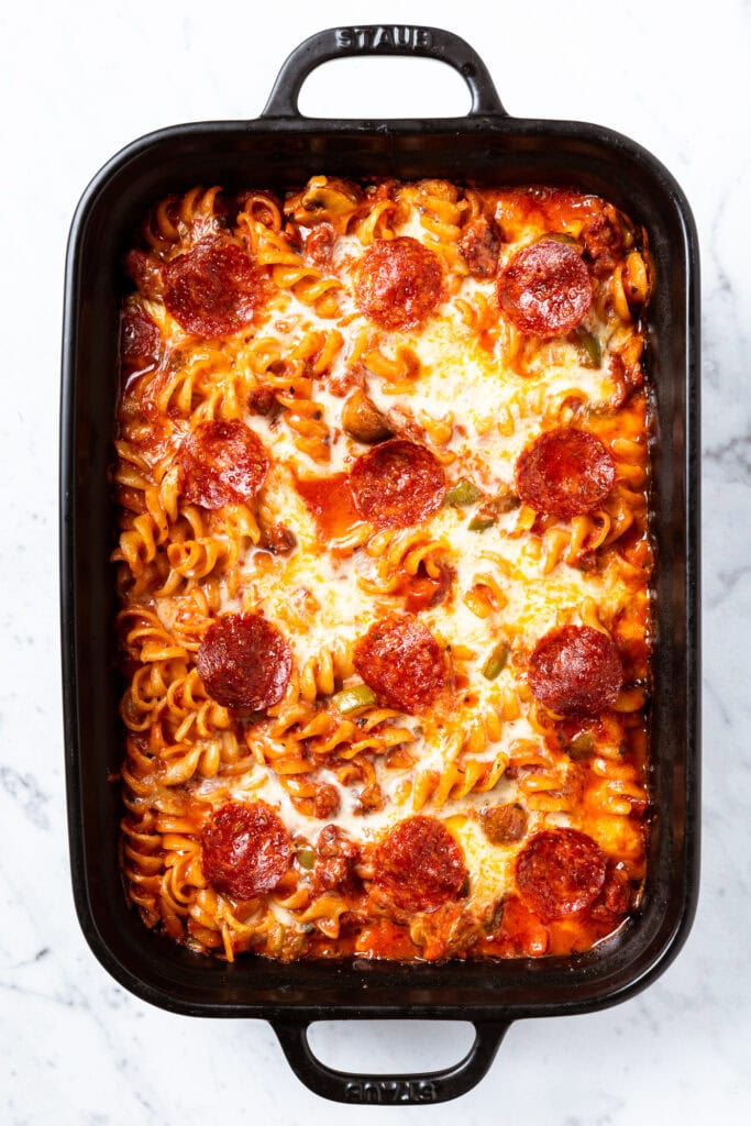 A fully baked pizza casserole in a baking dish.