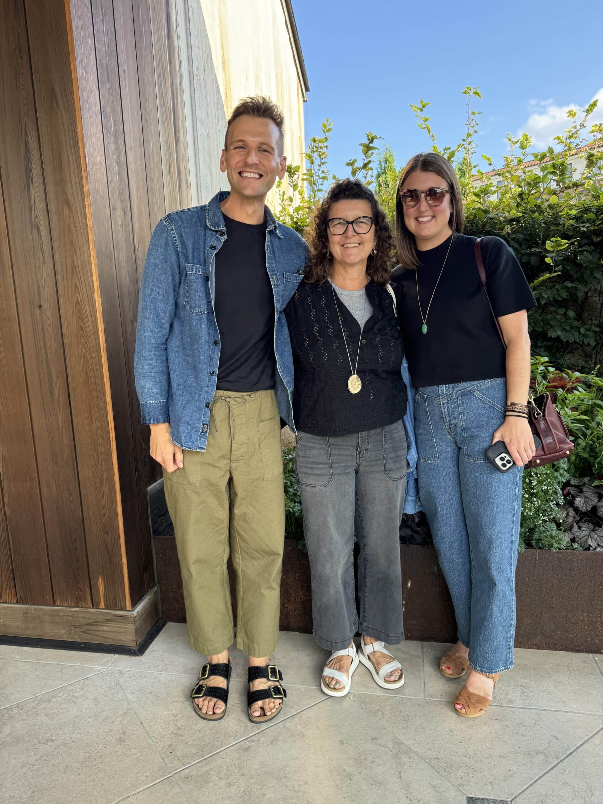 Kaleb Wyse standing in front of restaurant on a trip with his mom and sister.