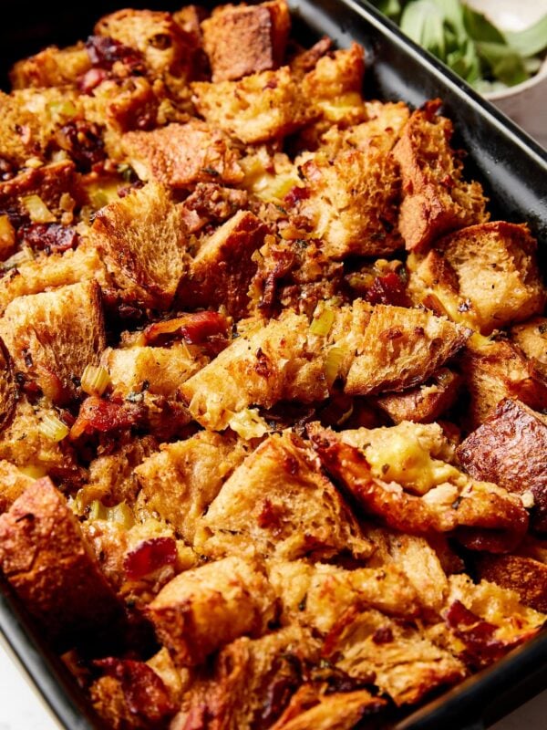 Black baking dish filled with cubes of bread to make a sausage stuffing for Thanksgiving.
