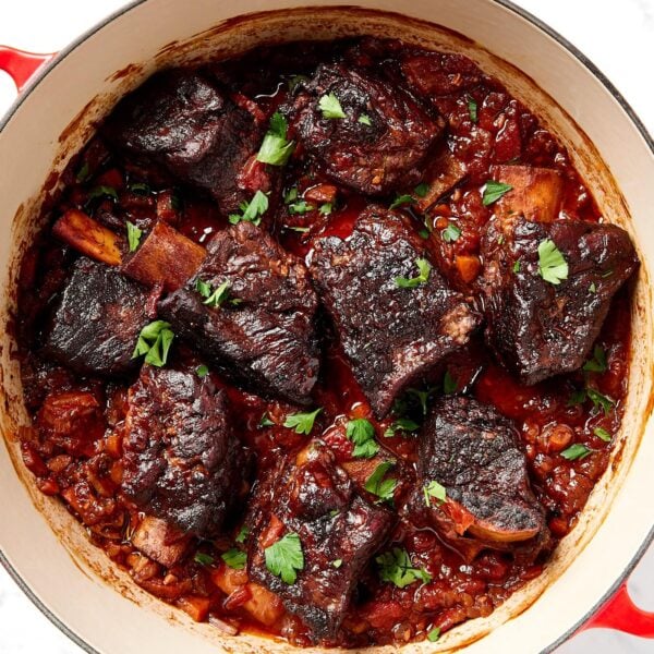 Braised short ribs sit in a Dutch oven after cooking.