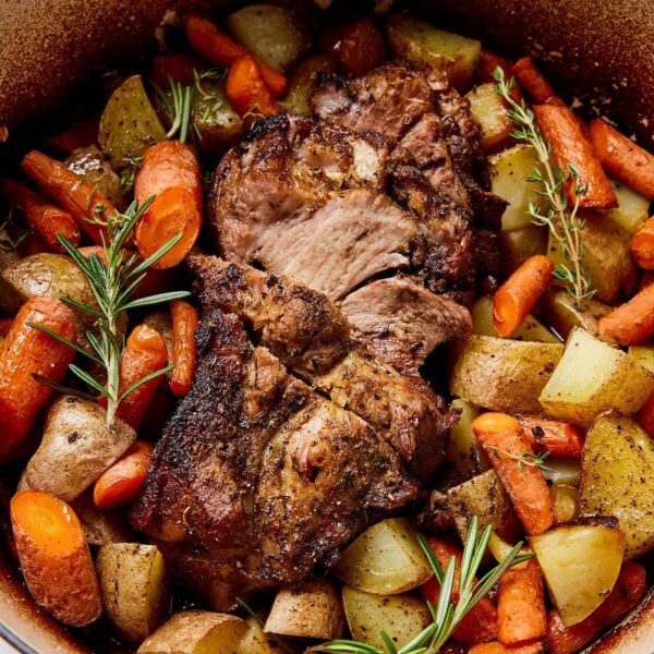 A pot filled with pork roast and vegetables.