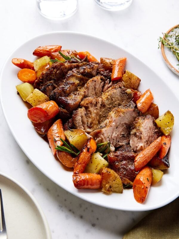 A plate with pork pot roast and vegetables.