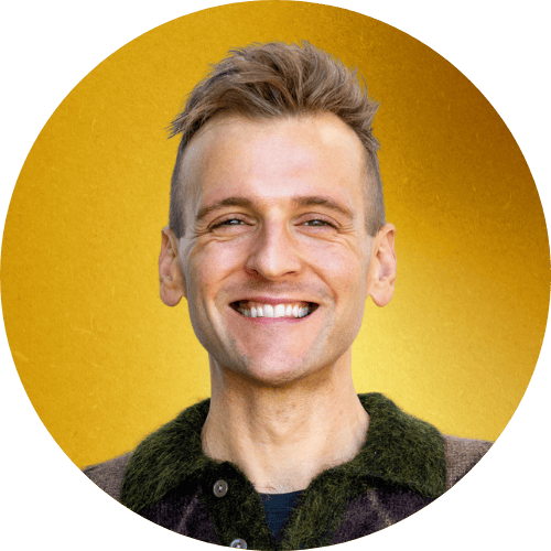 Kaleb Wyse standing in front of gold background.