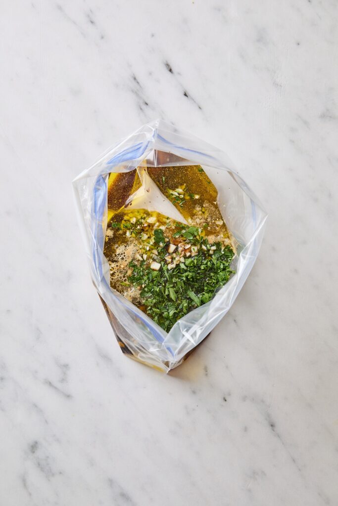 Plastic bag filled with ingredients for a steak marinade.