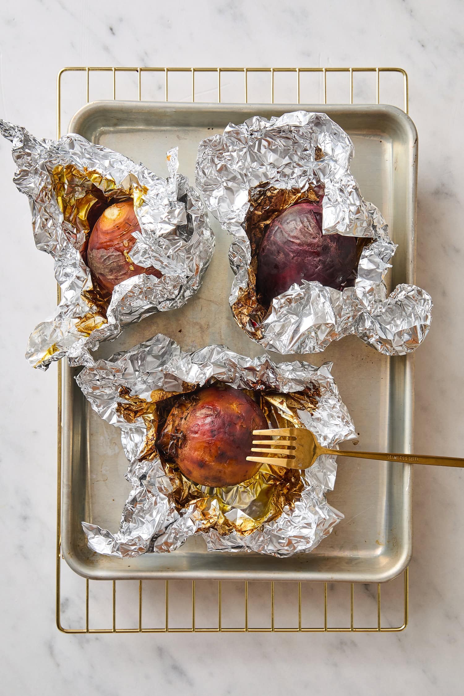 Roasted beets after being roasted in tin foil.
