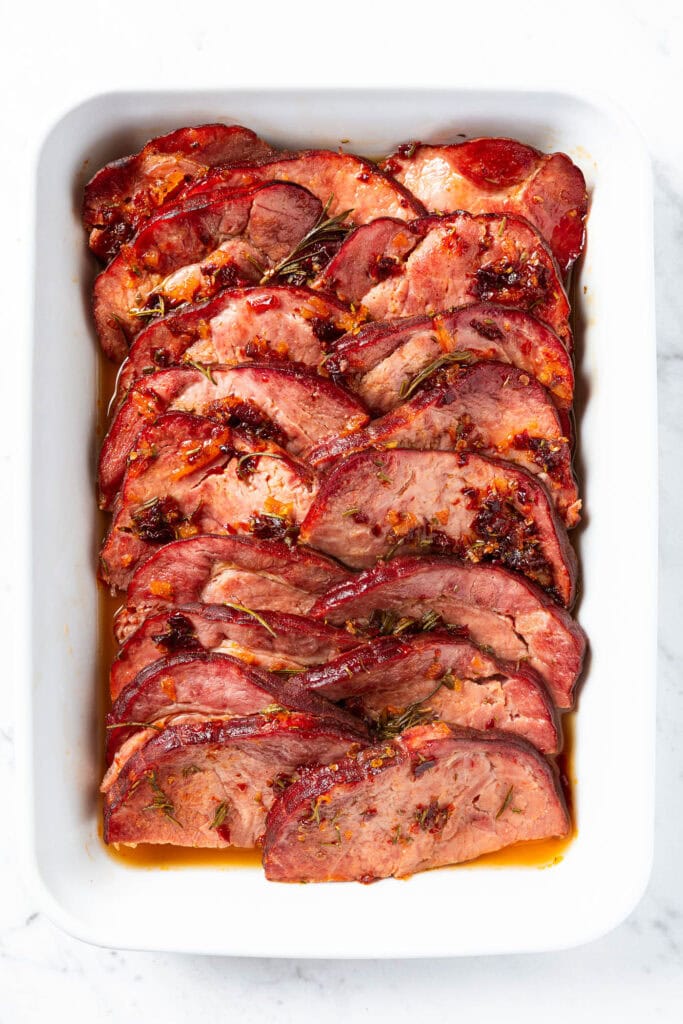 Sliced ham with orange chipotle glaze after baking.