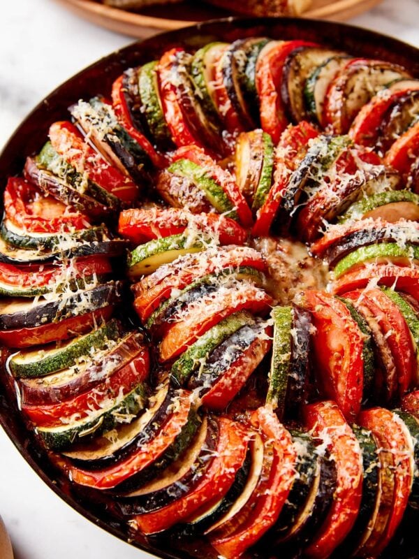 Ratatouille with Parmesan cheese sprinkled on top in black skillet.