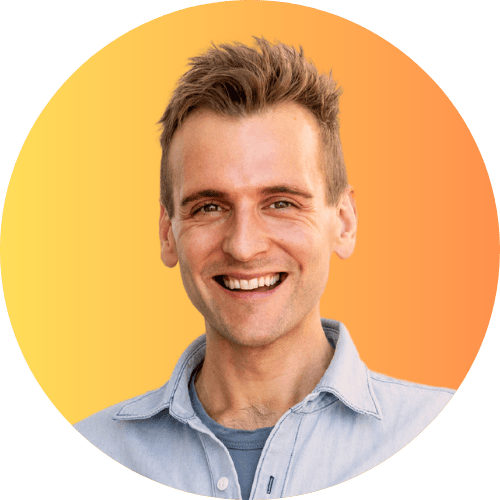 Kaleb Wyse standing in front of yellow and orange ombre background.