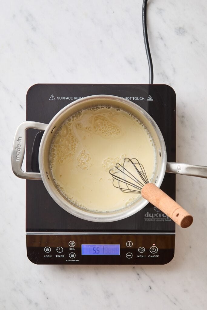 Vanilla pudding mixture cooking on a hot plate.