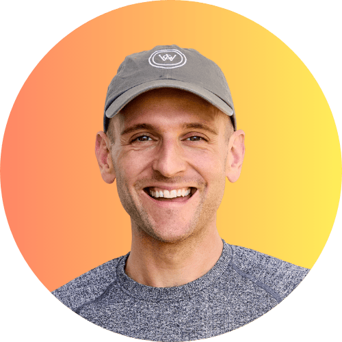 Kaleb Wyse wearing ball cap and standing in front of ombre orange to yellow background.