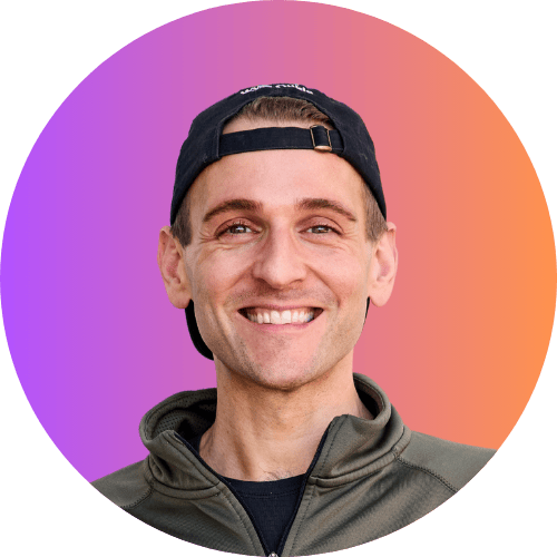 Kaleb Wyse standing in front of orange to purple background with backwards hat.