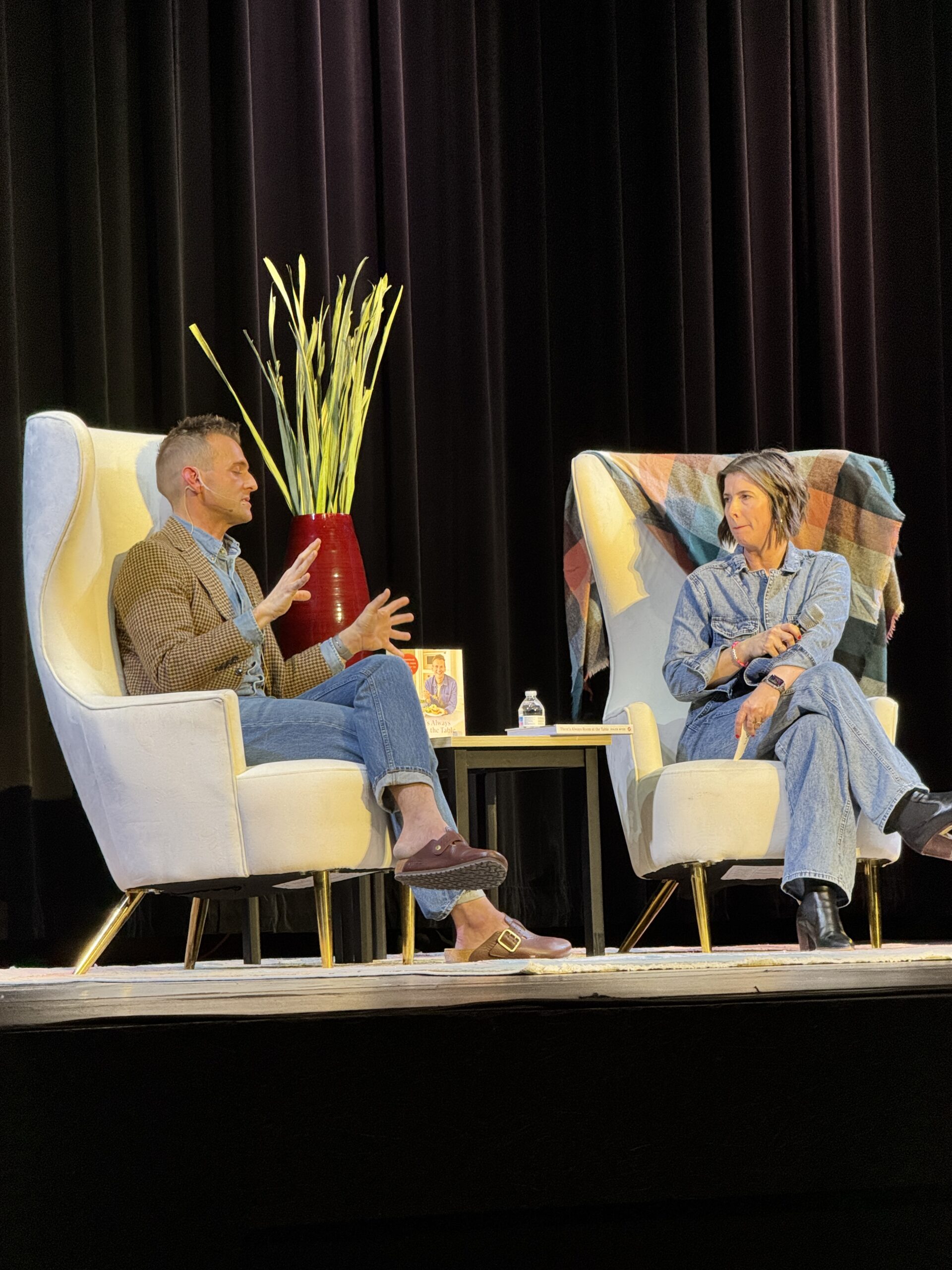 Kaleb Wyse onstage talking to Carrie Boyd for book promotion.