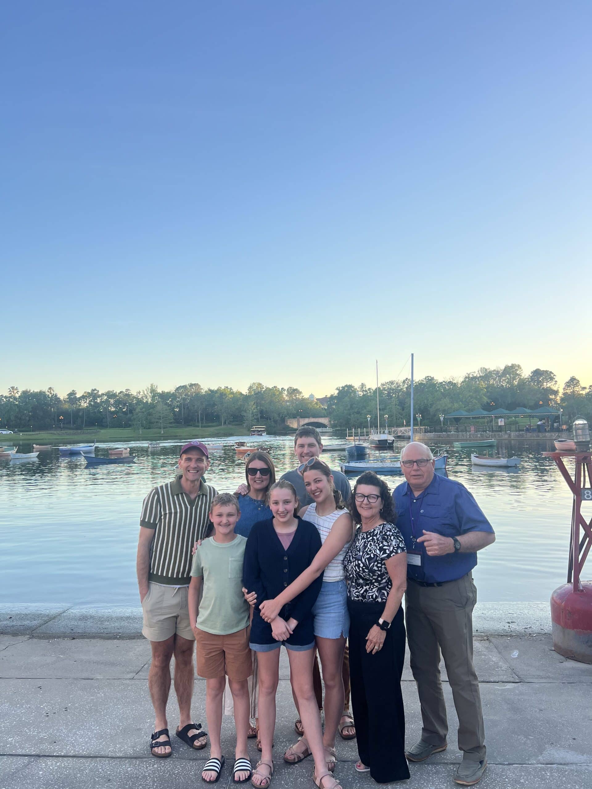 Kaleb Wyse standing with his extended family in front of a lake on vacation.