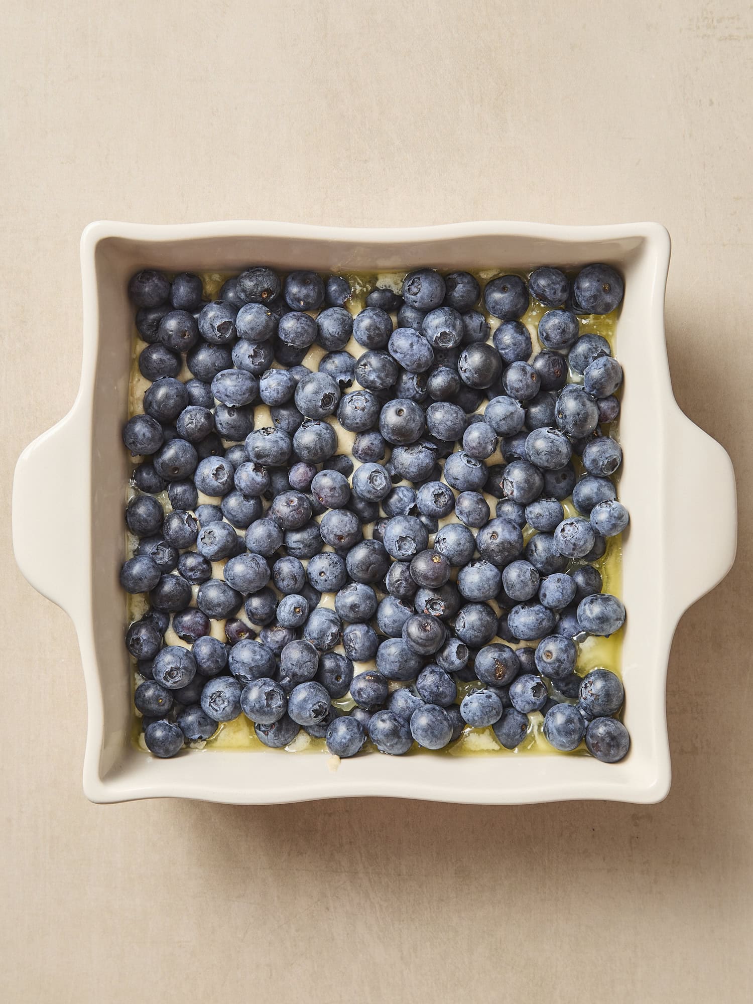 Unbaked cobbler with raw blueberries on top before going in the oven.
