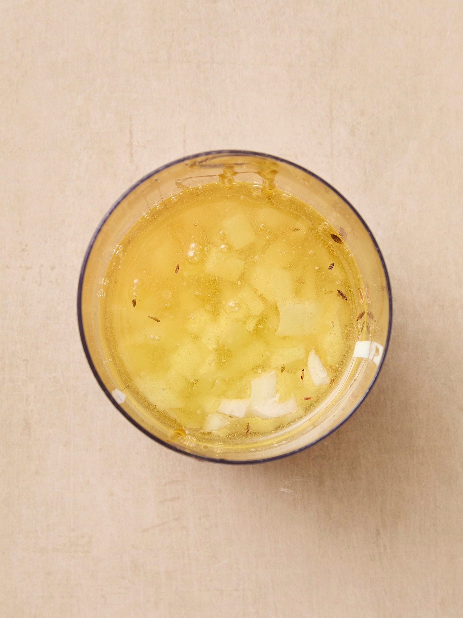 Glass container with ingredients for dressing before being mixed together.