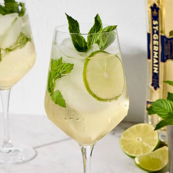 Wine glass with mint sprigs and lime wheel for a light spritz.