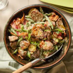 A bowl full of green bean and potato salad.