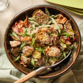 A bowl full of green bean and potato salad.
