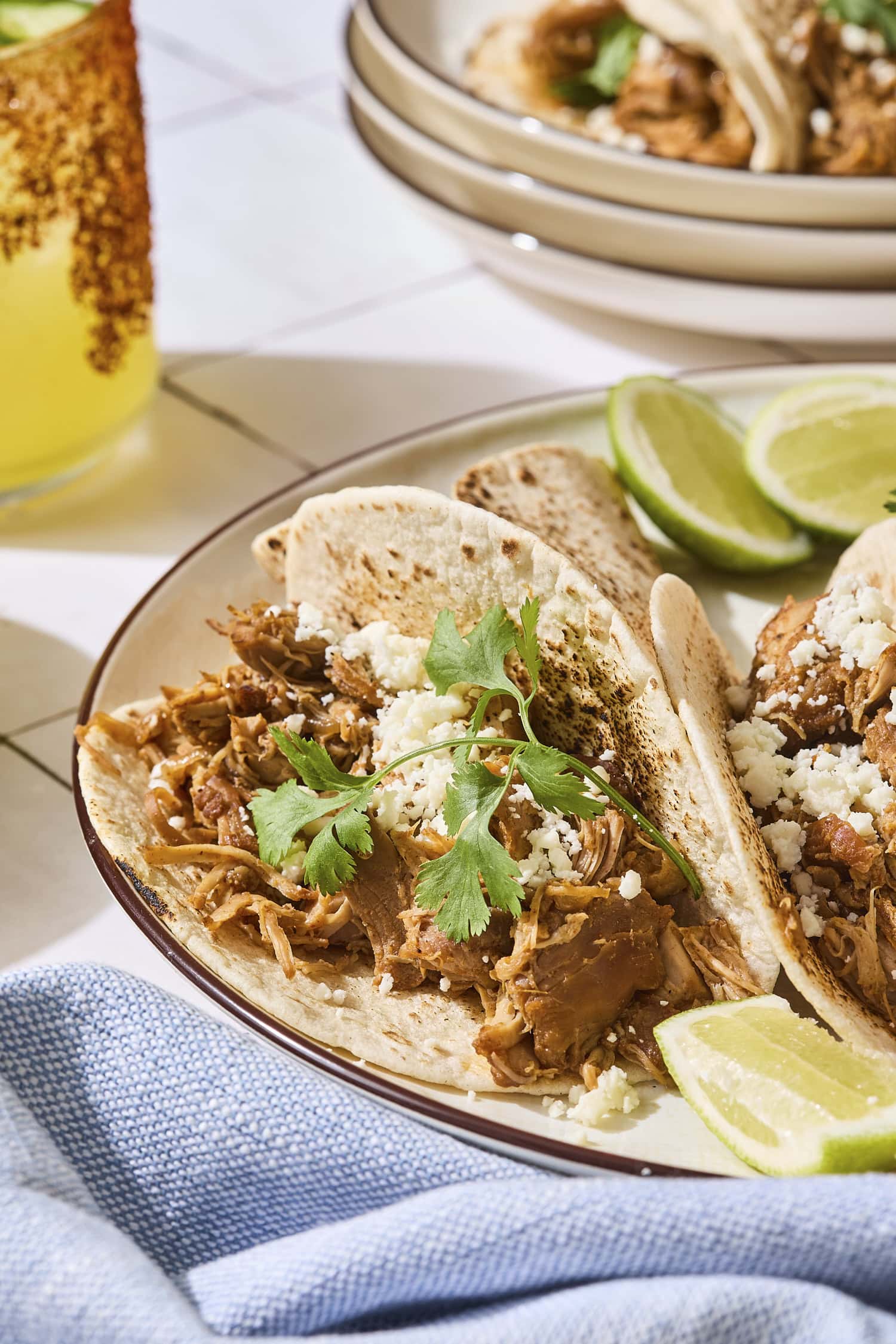Cilantro on a small chicken taco on a plate.