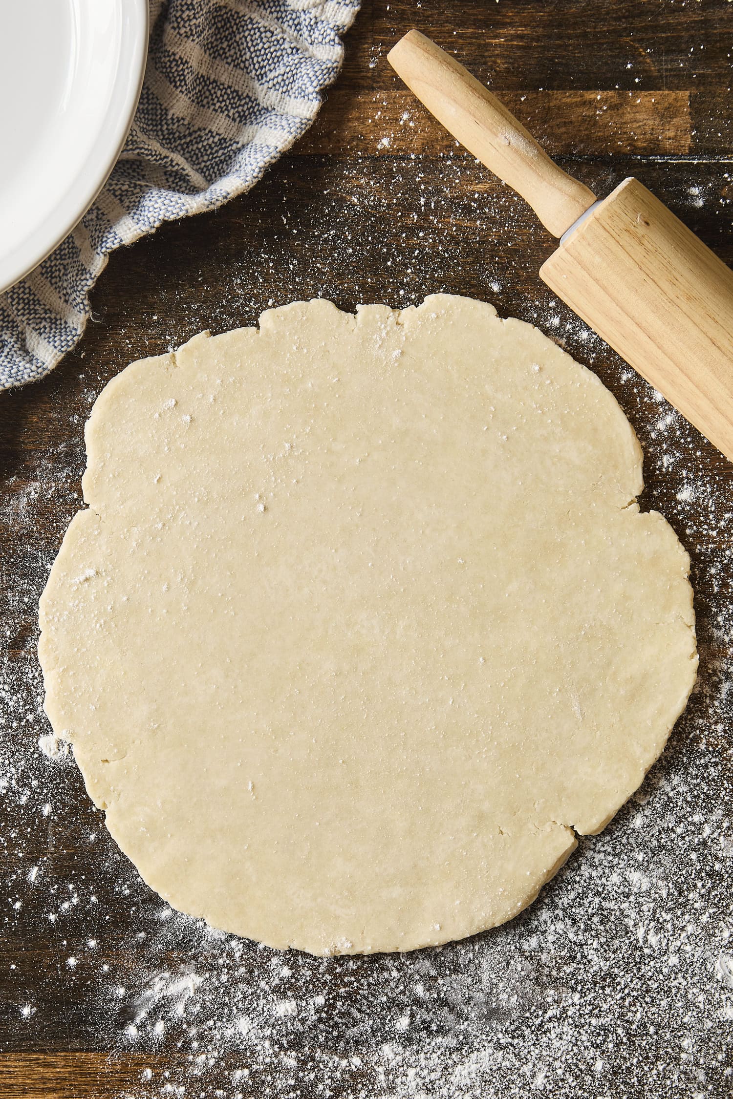 Rolled out pie dough on wooden surface.