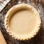 Pie crust with crimped edge before being baked.