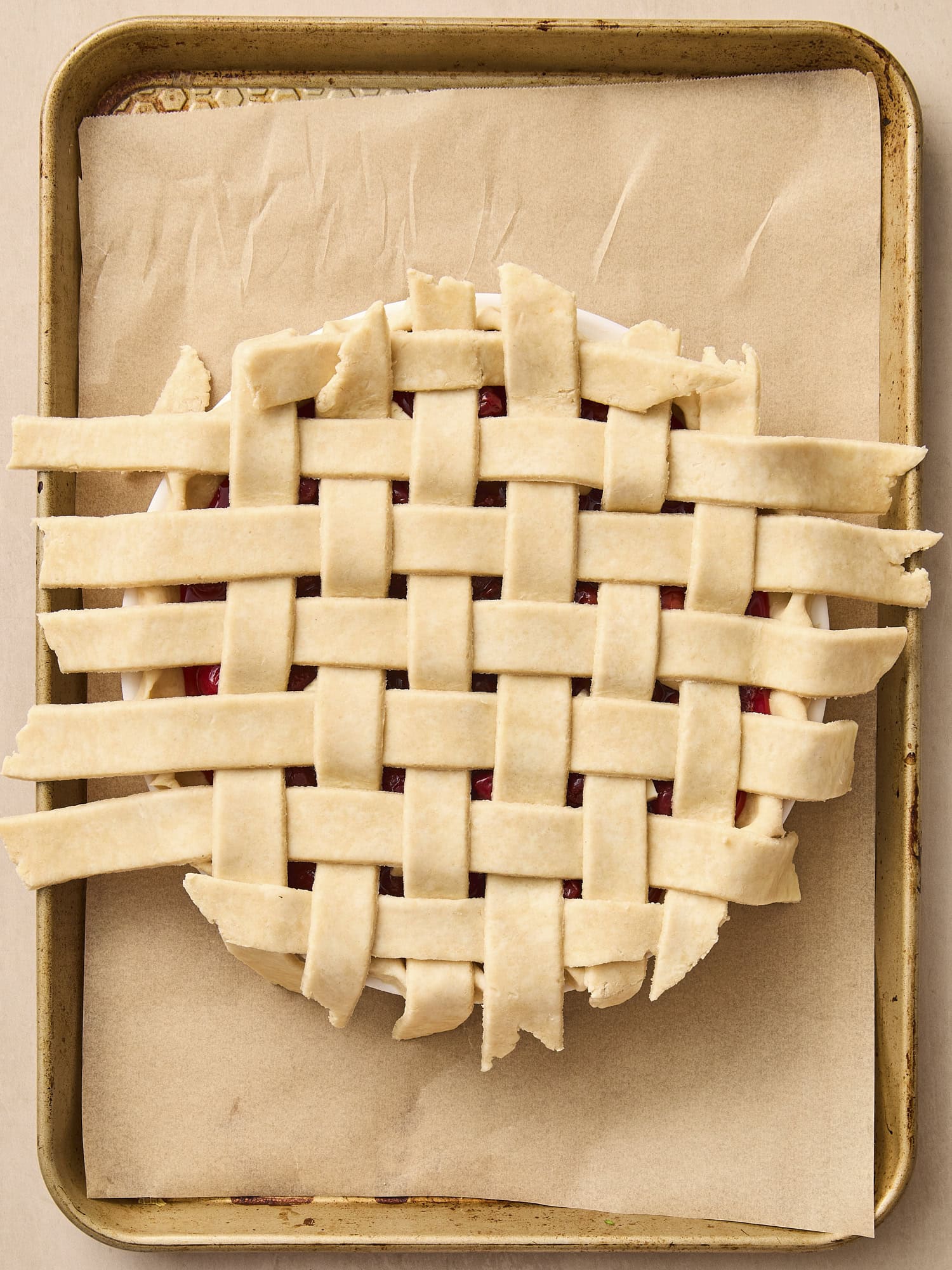 Lattice work on top of pie on baking pan.