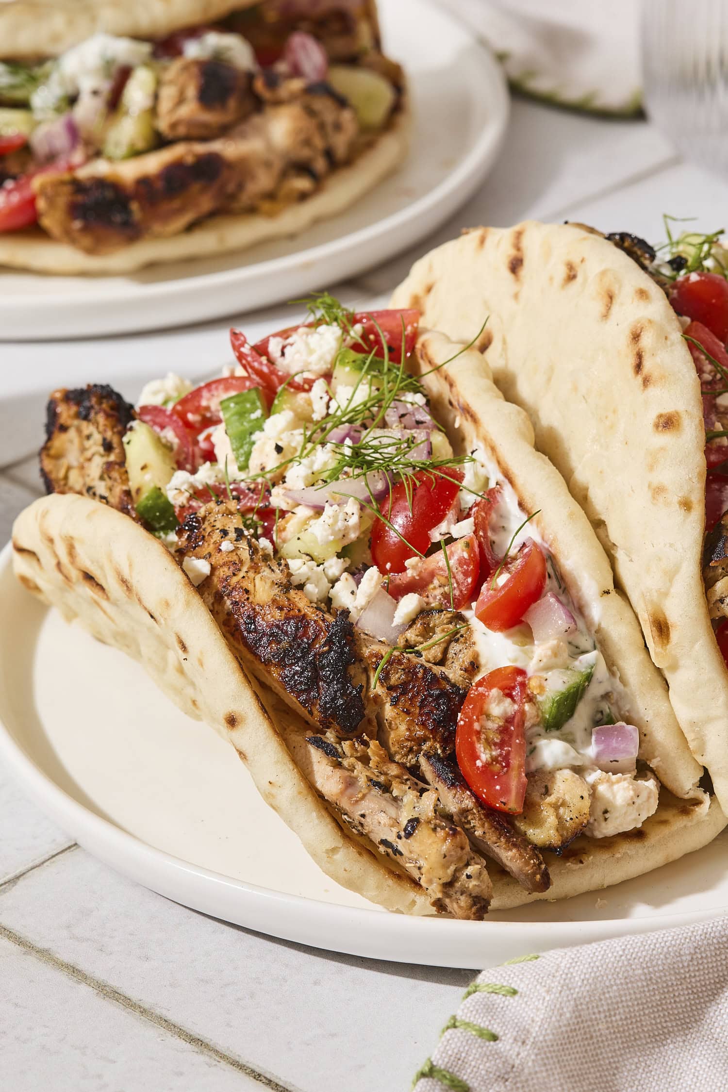 Chicken gyro wrapped in a pita with Greek salad topping.