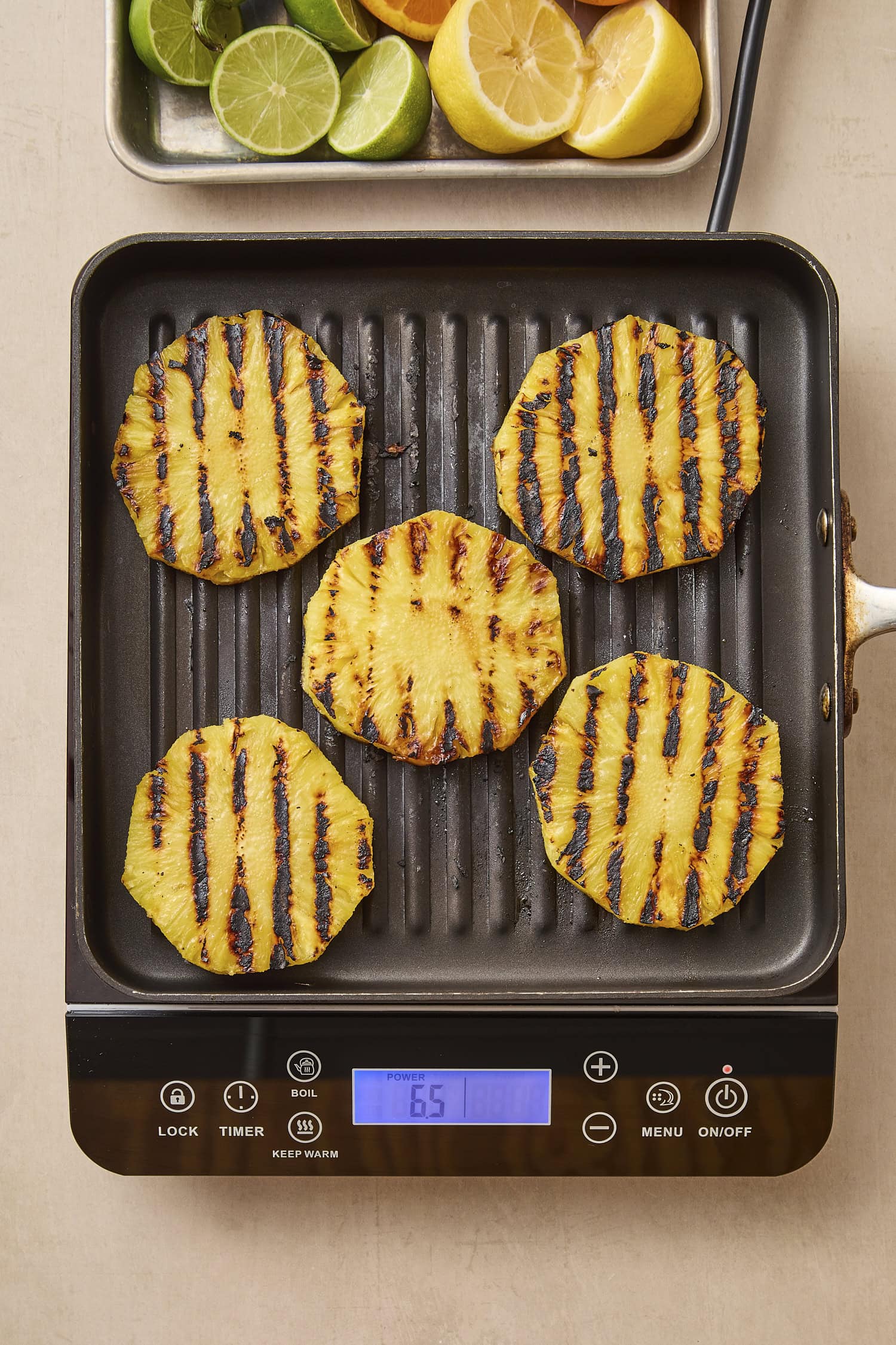 Grill pan with slices of grilled pineapple.