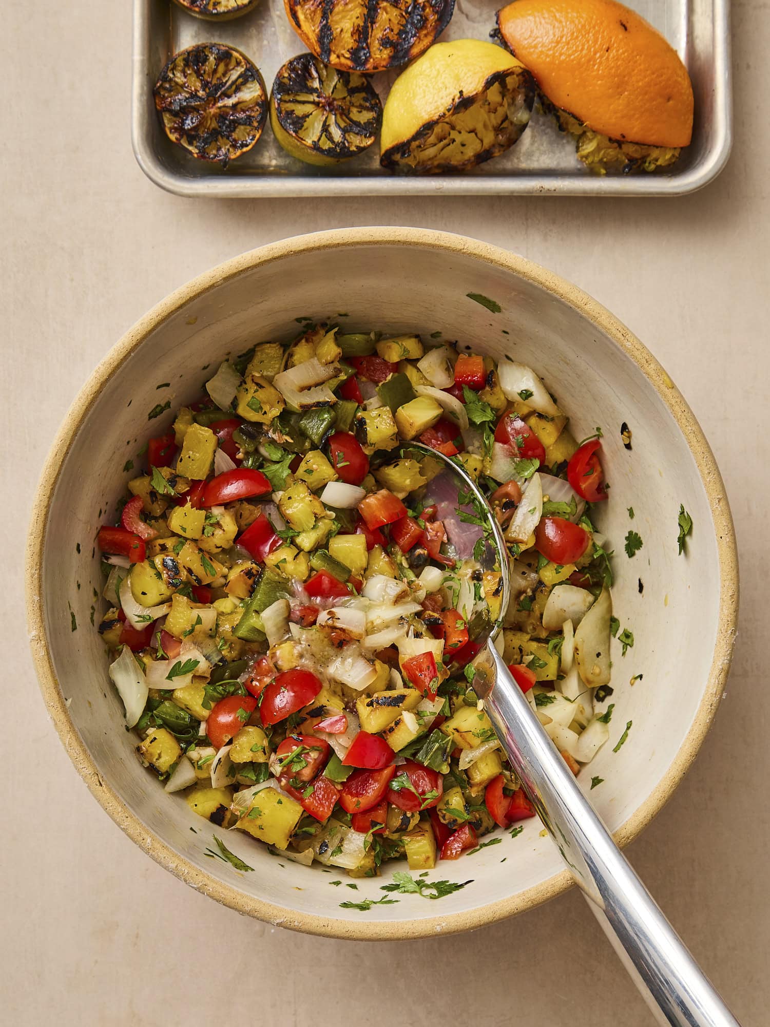 Bowl mixing together ingredients for pineapple salsa.