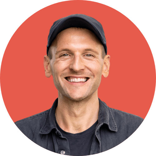 Kaleb Wyse wearing black hat standing in front of red background.