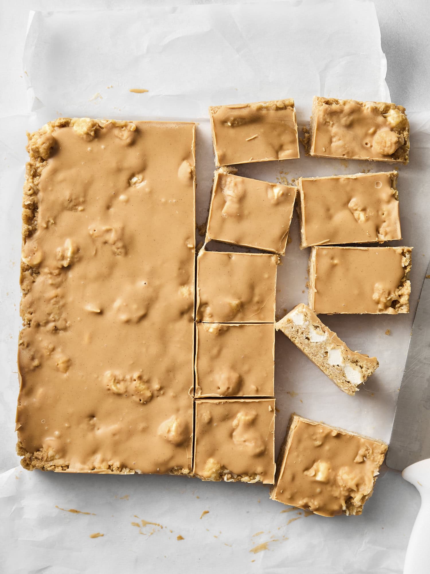 Prepared butterscotch bars on a piece of parchment after being sliced.