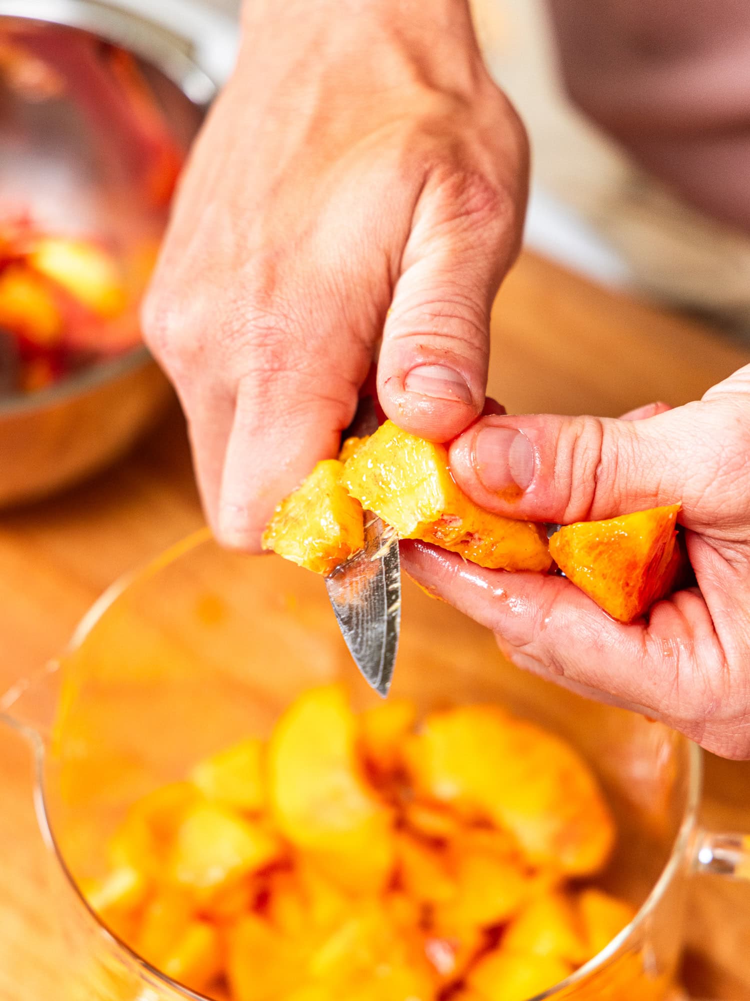 Cutting peaches into chunks.