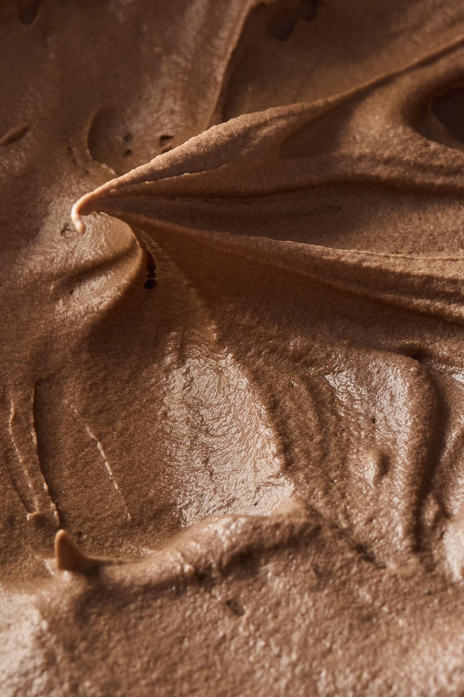 Swirl of chocolate frosting showing texture and creaminess.