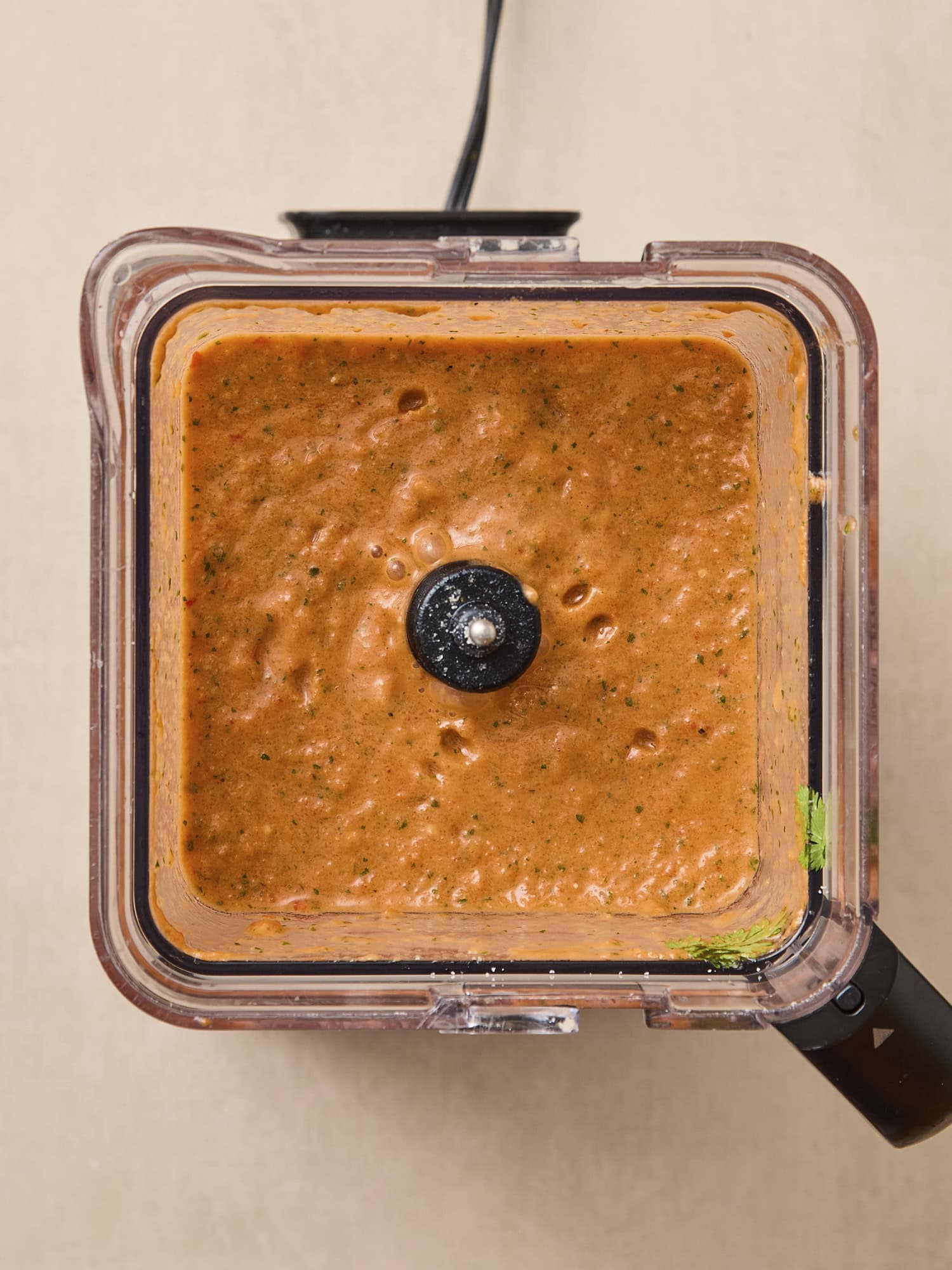 Blender with gazpacho inside after being blended together.
