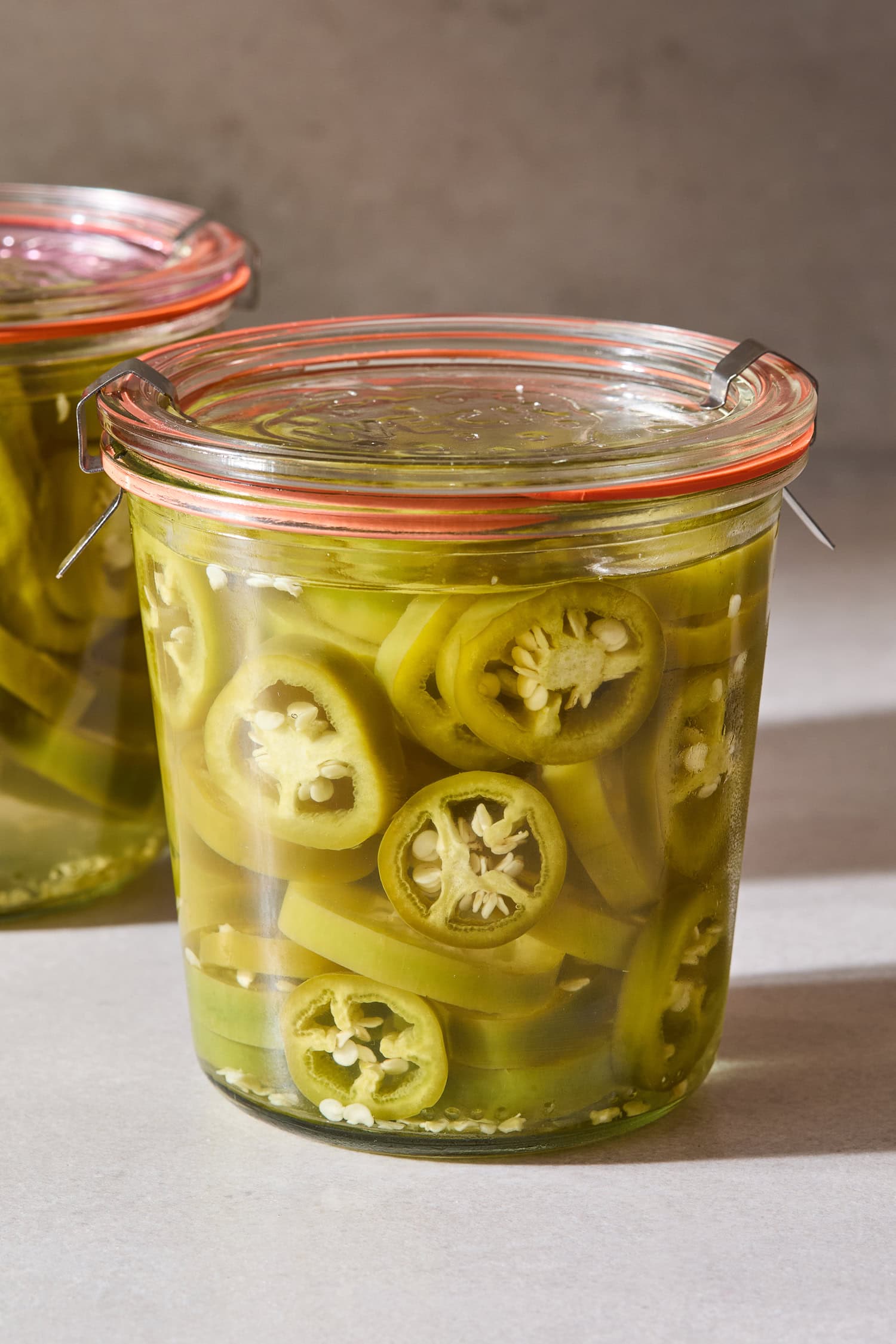 A jar filled with jalapeños after being quick pickled.