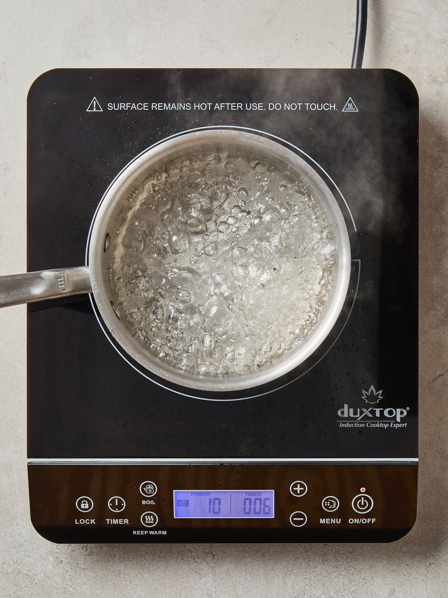 A vinegar brine boils on a cooktop.