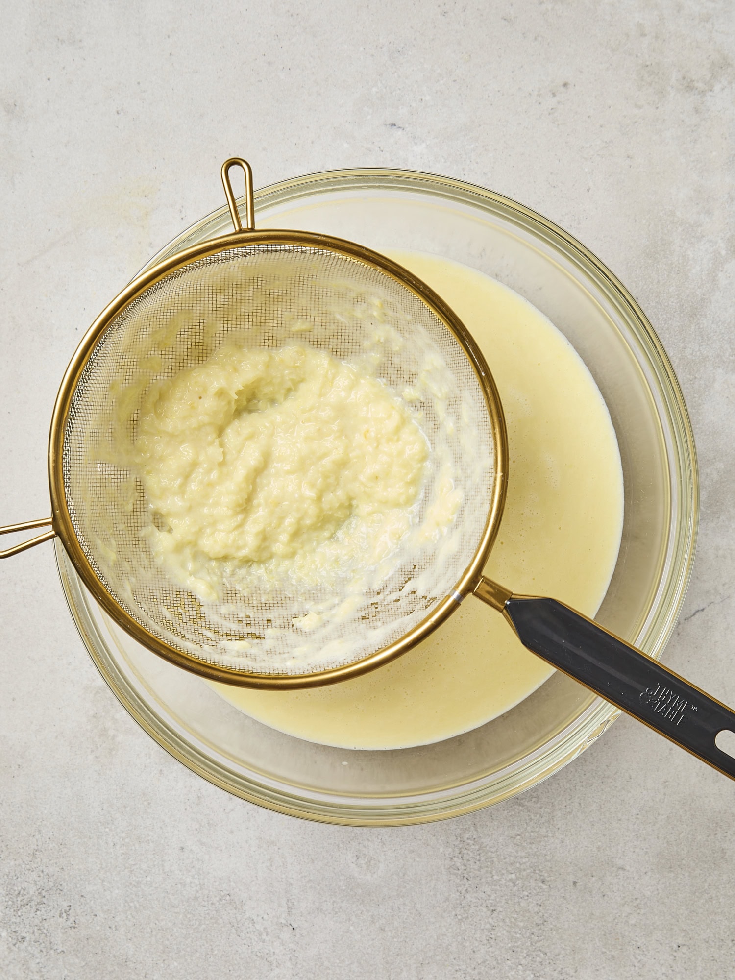 Strainer with remnants of sweet corn puree for a homemade ice cream.