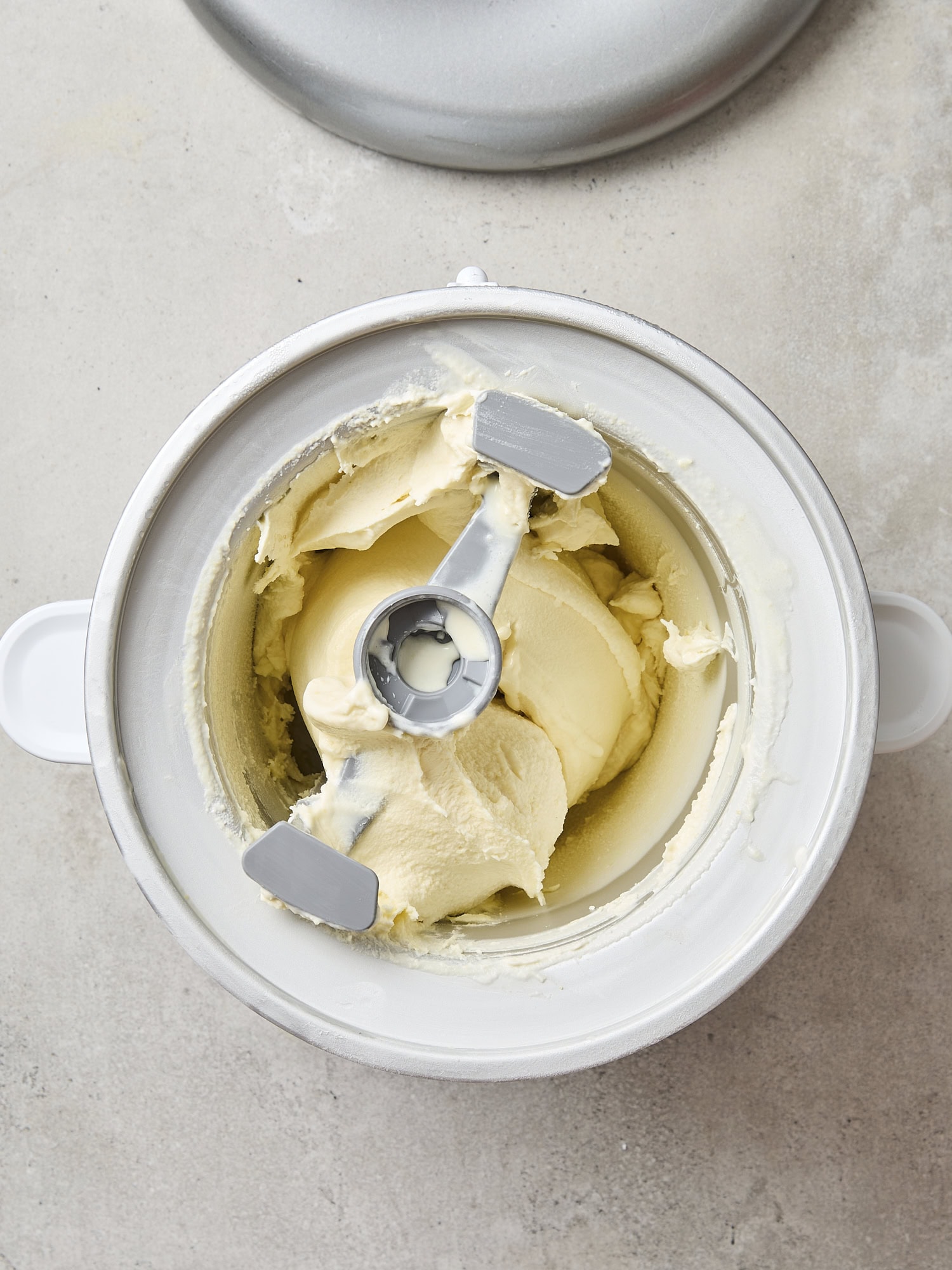 Container filled with churned soft sweet corn ice cream.