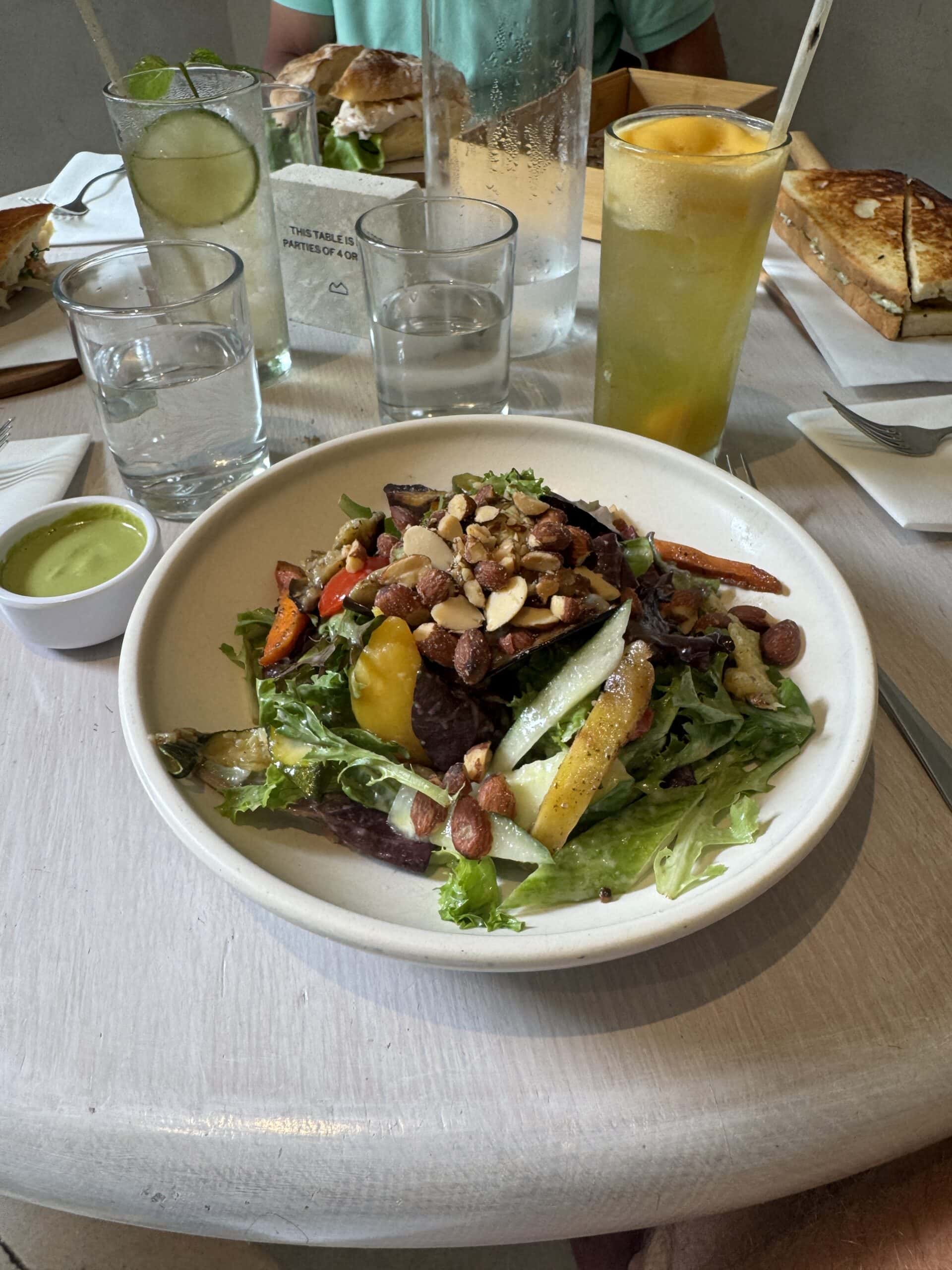 A salad in a stoneware bowl at a restaurant.
