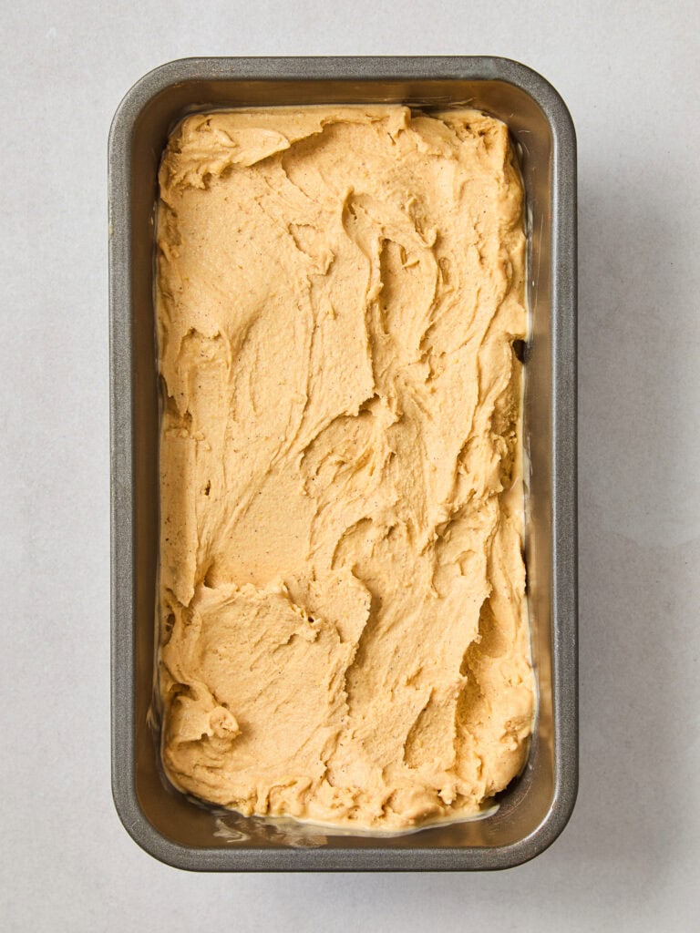 Pumpkin ice cream in a tin to be frozen.