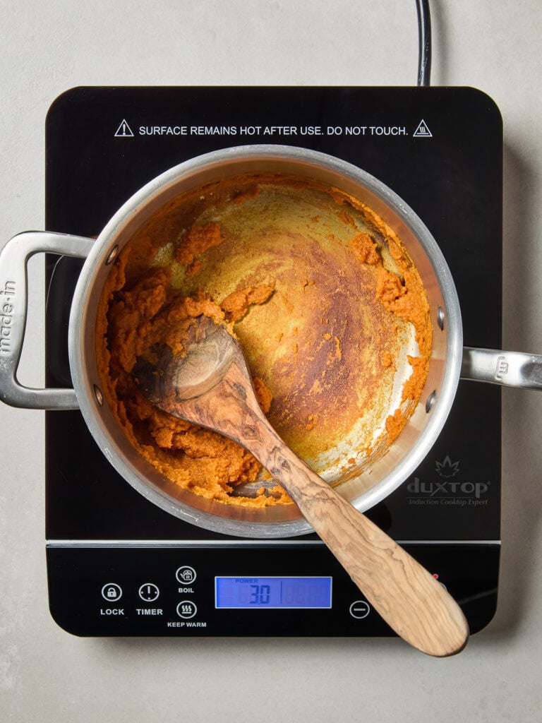 Pumpkin puree after cooking down on a stove.